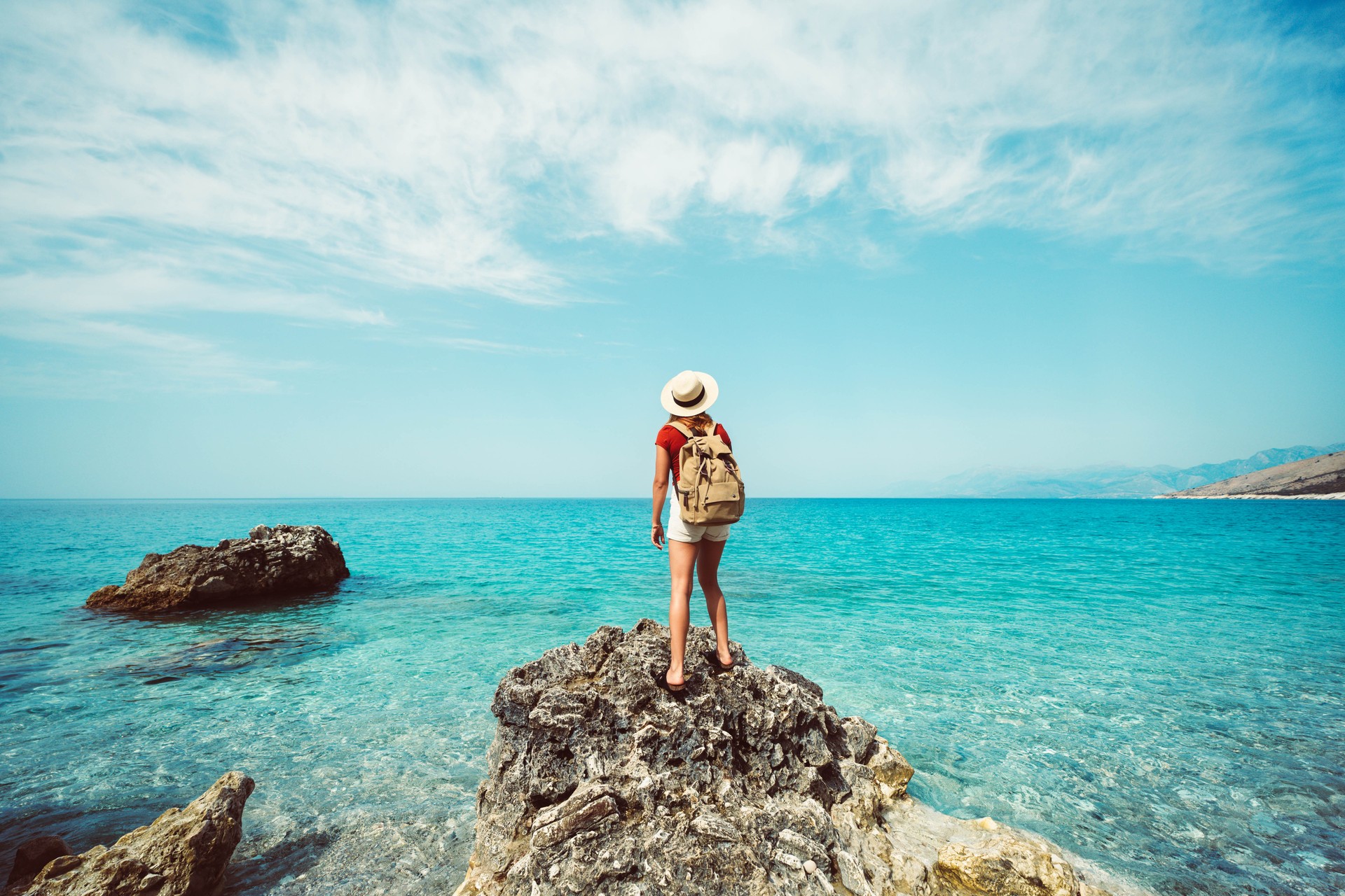 Strong confidence woman with backpack relaxing at seaside - Happy traveler enjoying freedom in serene nature landscape - Trip adventure, healthy lifestyle and mental health